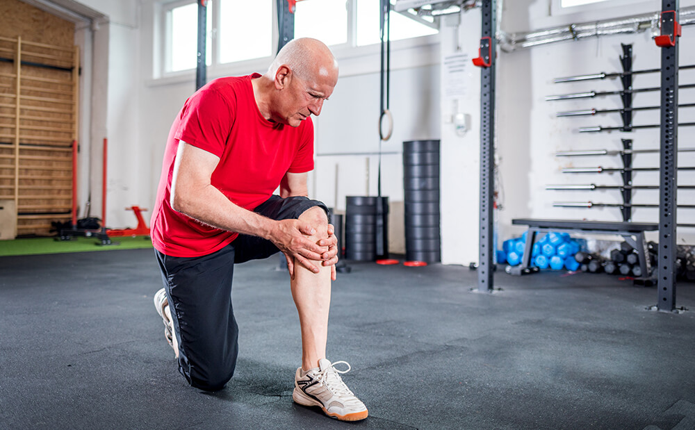 Lower leg pain after knee replacement? Here's why and how to manage it senior man at the gym suffering from pain in knee 2021 08 30 00 36 09 utc 1 Lower leg pain after knee replacement? Here’s why and how to manage it