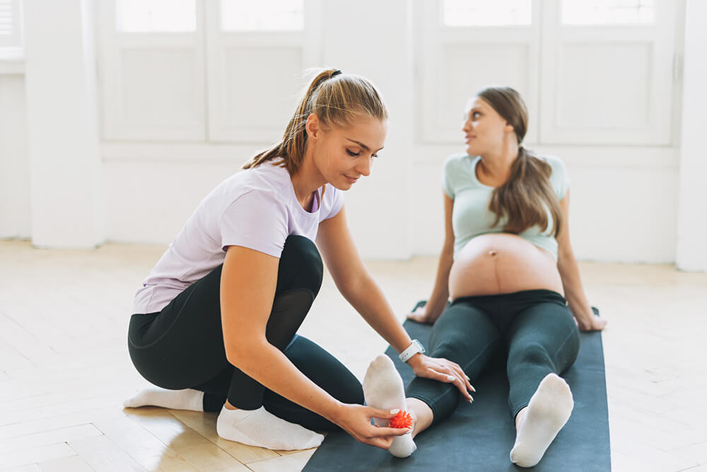 8 expert suggestions for managing postpartum foot pain the trainer massages pregnant woman s feet with sp 2022 11 12 05 18 26 utc 8 expert suggestions for managing postpartum foot pain