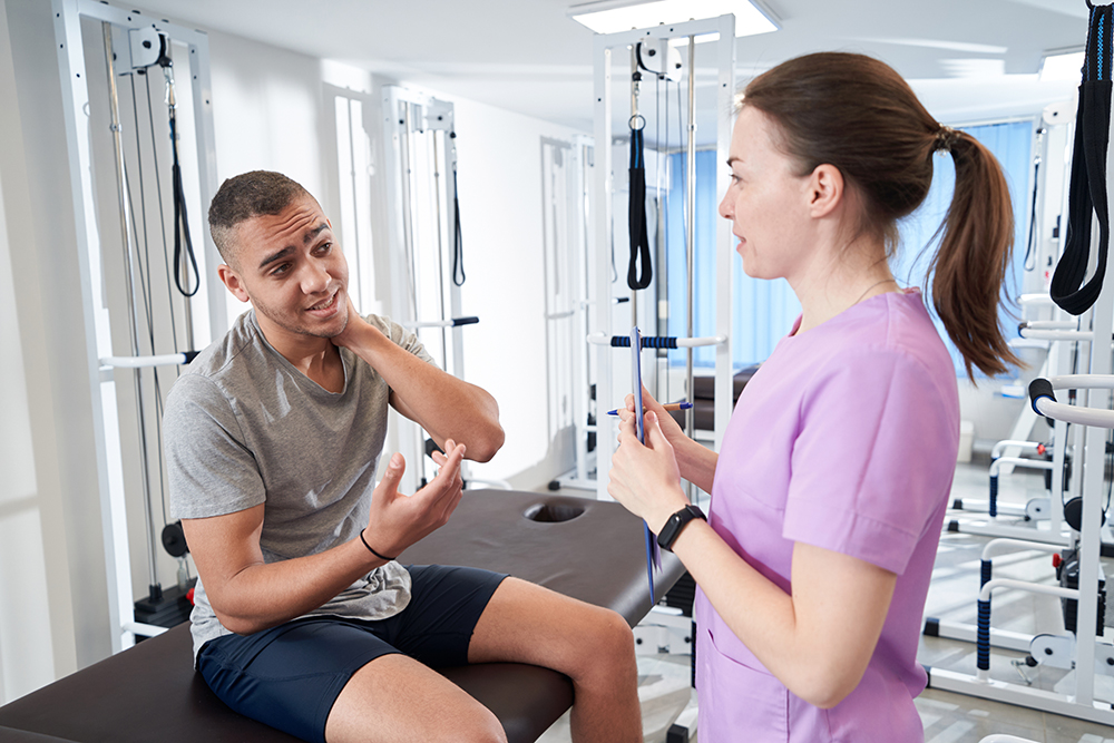 Does physical therapy work? The science behind the treatment african american man talking with doctor in physic 2022 09 01 02 15 39 utc 1 Does physical therapy work? The science behind the treatment